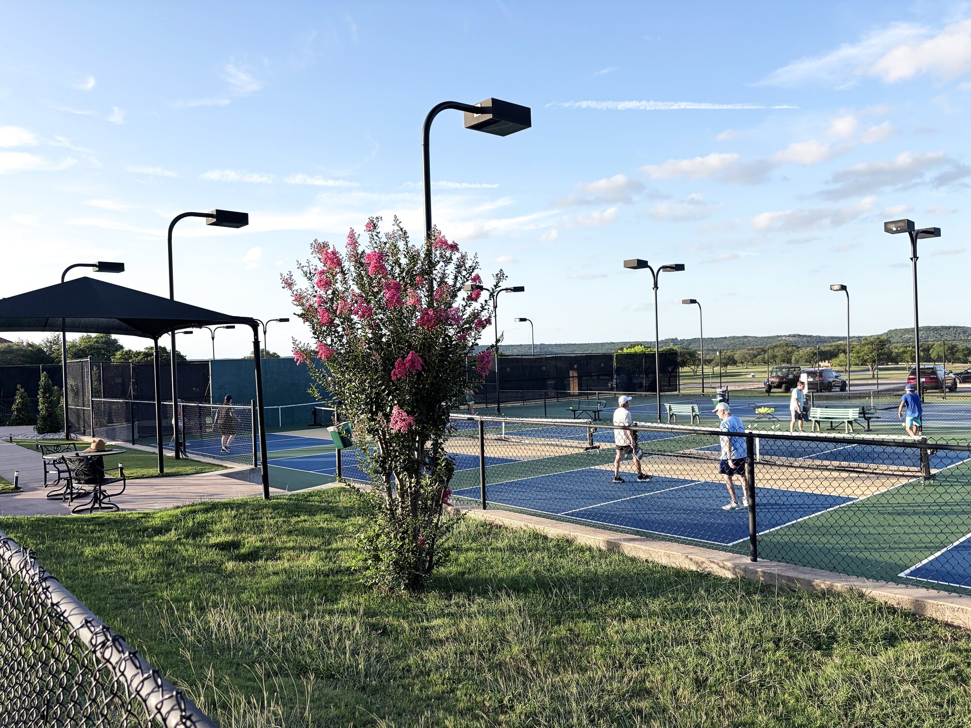Members playing tennis on a hard court at Lakecliff Racquet Club