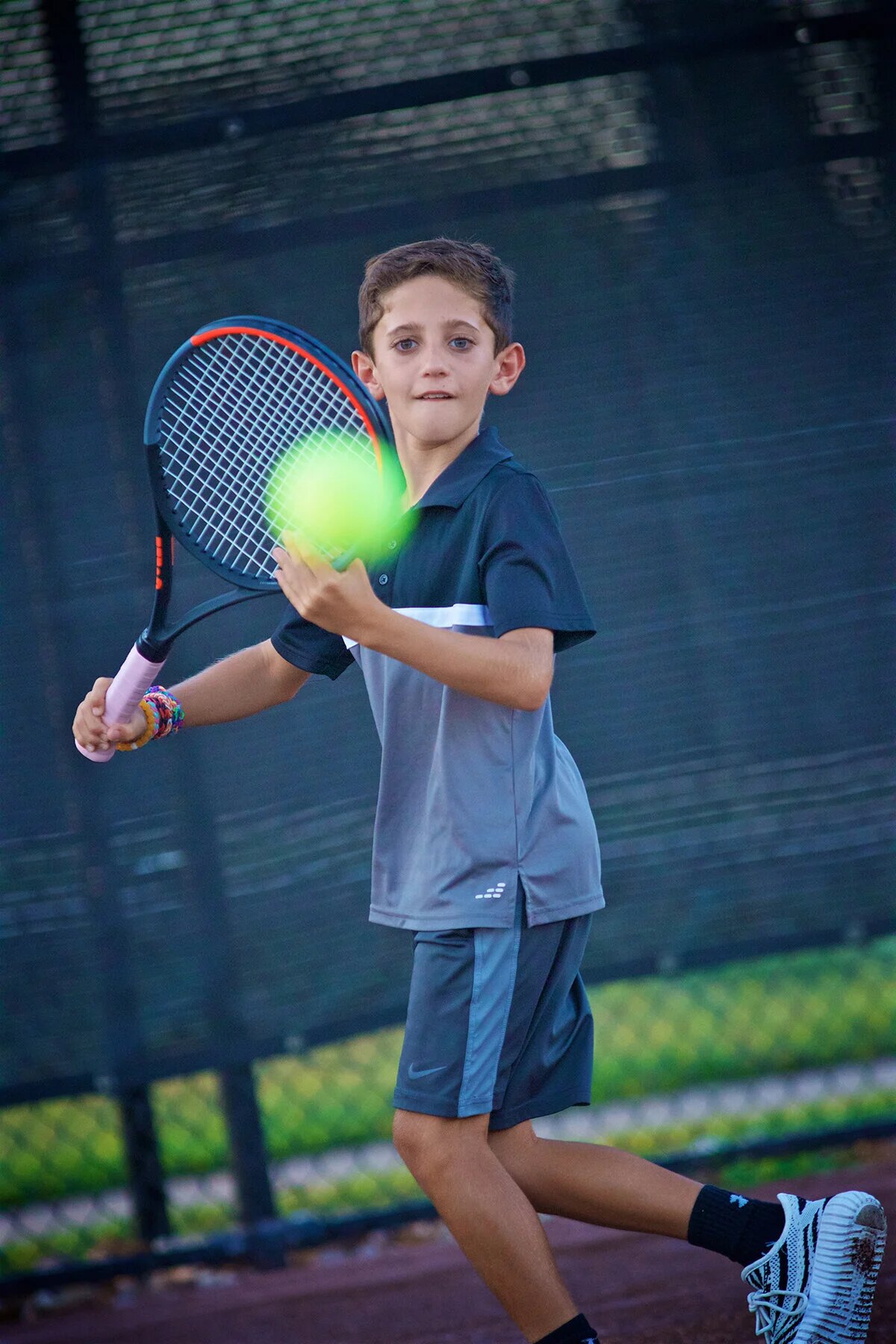 Junior academy player hitting a ball